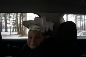 Kid in car with fish hat