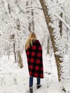 girl walking in snowy woods