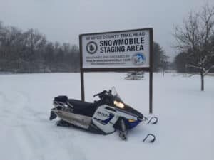 Snowmobile by Newaygo staging area sign