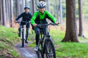 Kids on mountain bikes on trail