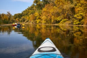 Kayaks on river in fall